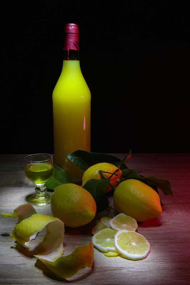food sliced lemon beside glass bottle fruit